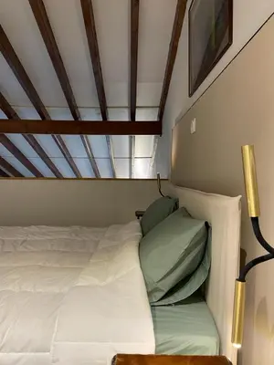 a bedroom with a white bed with green pillows at Calming Mountain View Apt with Balcony & Free Parking near Kakopetria in Nicosia
