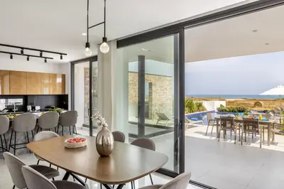 a kitchen and dining room with a table and chairs at Villa Pliades in Ayia Napa