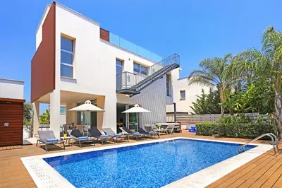 a swimming pool in front of a house at Villa Sunrise Memory - 150m from Trinity Beach in Protaras
