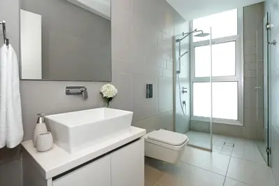 a white bathroom with a sink and a toilet at Villa Sunrise Memory - 150m from Trinity Beach in Protaras