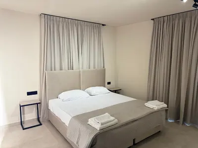 a bedroom with a large bed and a window at Home of the Muses in Ayia Napa