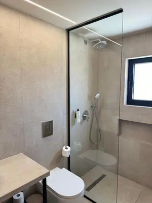 a bathroom with a shower and a toilet at Home of the Muses in Ayia Napa