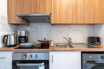 a kitchen with a sink and a stove at Arion 1-Bedroom Apartment in Larnaca in Larnaka