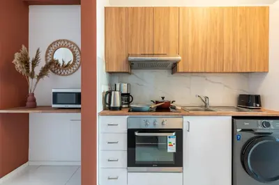 a kitchen with a stove and a dishwasher at Arion 1-Bedroom Apartment in Larnaca in Larnaka