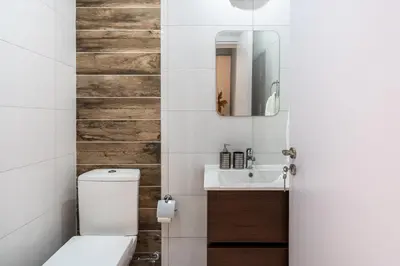 a bathroom with a toilet and a sink at Hue 1-Bedroom Apartment in Larnaca in Larnaka