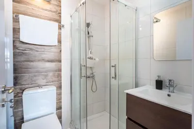 a bathroom with a shower and a toilet and a sink at Hue 1-Bedroom Apartment in Larnaca in Larnaka