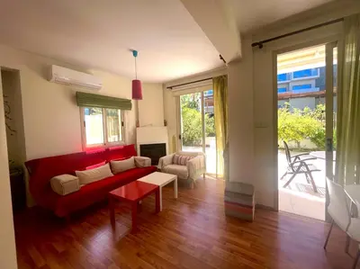 a living room with a red couch and a table at Platform 357 Mimoza Villa with View in Paralimni