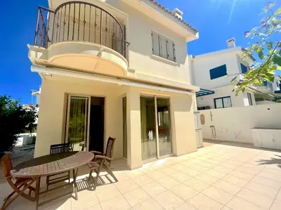 a patio with a table and chairs in front of a house at Platform 357 Mimoza Villa with View in Paralimni