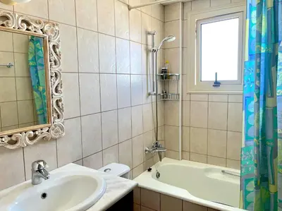 a bathroom with a sink and a tub and a mirror at Platform 357 Mimoza Villa with View in Paralimni