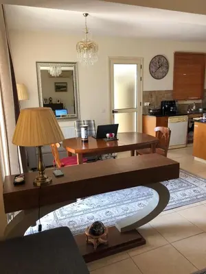 a living room with a table and a kitchen at Budget Escape to the seaside in Larnaka