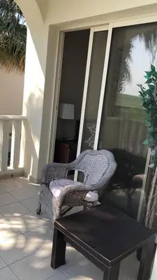 a chair and a coffee table on a porch at Budget Escape to the seaside in Larnaka