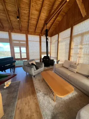 a living room with a couch and a piano at Serenity Mountain in Askas