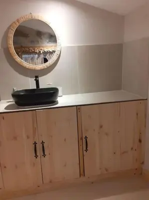 a bathroom counter with a mirror and a sink at Serenity Mountain in Askas