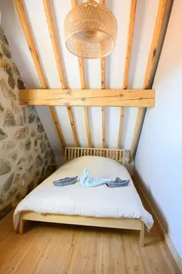 a small bed in a room with a ceiling at Serenity Mountain in Askas