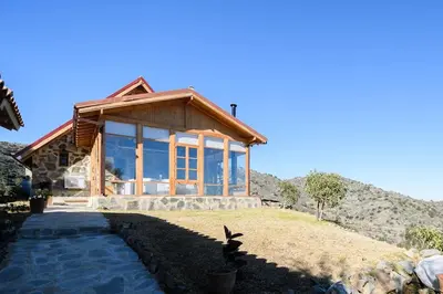 a house on top of a hill with a house at Serenity Mountain in Askas