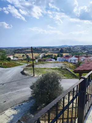 an empty street with a fence and a road at Mariam Apartment in Larnaka