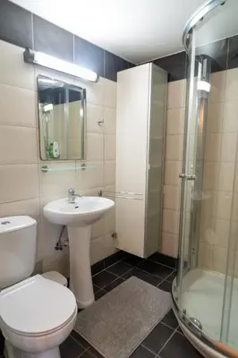 a bathroom with a toilet and a sink and a shower at Finikoudes Seaview Vibe 1 Bdr Flat in Larnaka