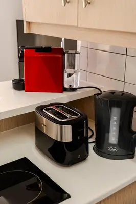 a toaster and a toaster on a kitchen counter at Finikoudes Seaview Vibe 1 Bdr Flat in Larnaka