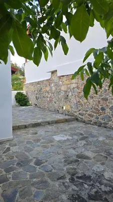 a stone walkway next to a stone wall at GPPh in Pelendri