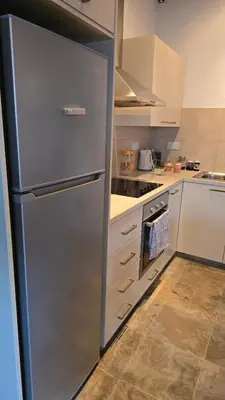 a kitchen with a stainless steel refrigerator at GPPh in Pelendri