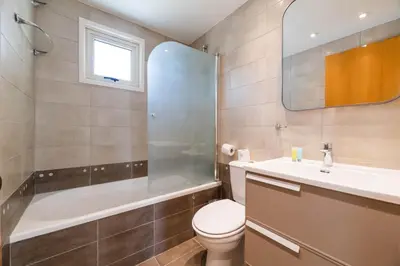 a bathroom with a toilet and a sink and a shower at Pernera Blue Villa in Protaras