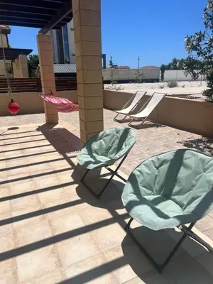 a couple of chairs sitting on a patio at Villa Calm 100m from the beach in Ayia Napa