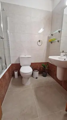 a bathroom with a toilet and a sink at City Center Apartment 2 in Nicosia