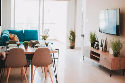 a living room with a table and a blue couch at Mercury Apartment in Livadhia
