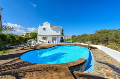a house with a swimming pool in front of a house at Villa Marilena in Protaras