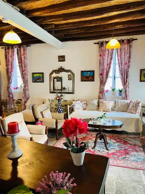 a living room with a couch and a table at Traditional House in Pera in Pera