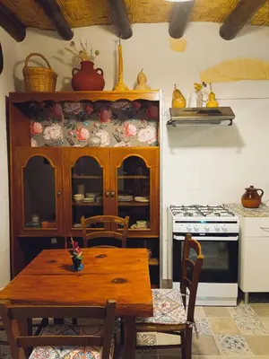 a kitchen with a wooden table and a stove at Traditional House in Pera in Pera