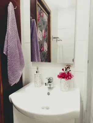 a bathroom with a white sink and purple towels at Traditional House in Pera in Pera