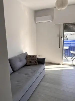 a living room with a couch with a pillow on it at Top floor Flat in Nicosia 2 in Nicosia