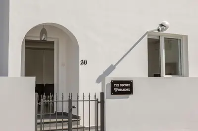 a sign on the side of a building with a gate at The Second Diamond Protara - 2' Walk to Beach in Protaras