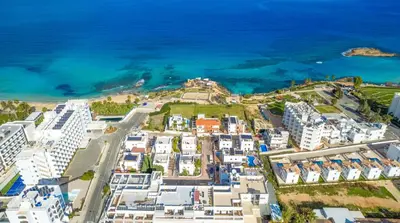 an aerial view of white buildings and the ocean at Silver Sands Penthouse in Protaras