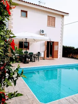 a villa with a swimming pool and a house at Villa Elena Gardens in Ayia Napa