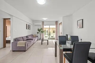 a living room with a couch and a table at Downtown 2 Bedroom Apartment in Larnaka