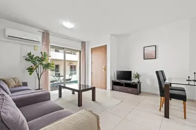 a living room with a couch and a table at Downtown 2 Bedroom Apartment in Larnaka