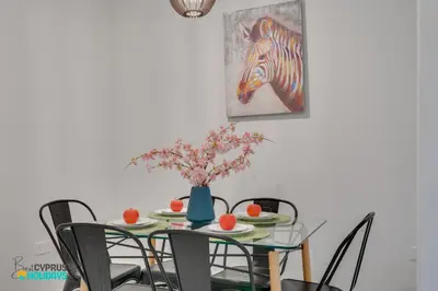 a dining room table with a painting of a zebra at Parrots Paradise 100m from Finikoudes beachfront in Larnaka