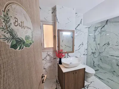 a bathroom with a sink and a toilet and a mirror at Parrots Paradise 100m from Finikoudes beachfront in Larnaka