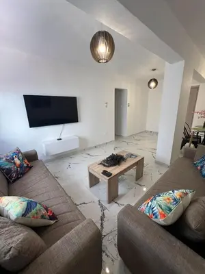 a living room with two couches and a coffee table at Parrots Paradise 100m from Finikoudes beachfront in Larnaka