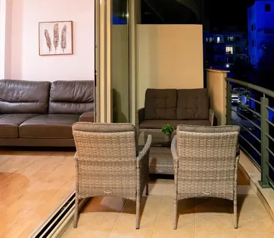 a living room with a couch and two chairs at Earth Apartment in Larnaka