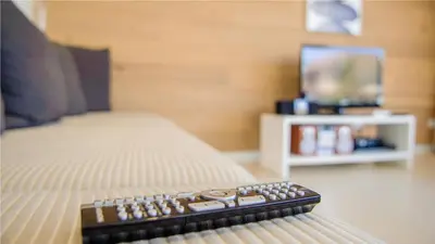 a remote control sitting on top of a bed at Protaras Holiday Villa 100 in Protaras