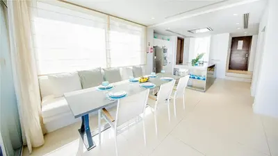 a kitchen and living room with a table and chairs at Protaras Holiday Villa 100 in Protaras