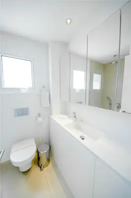 a white bathroom with a toilet and a mirror at Protaras Holiday Villa 100 in Protaras