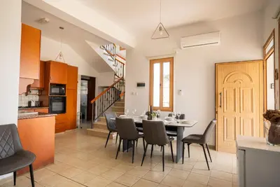 a kitchen and dining room with a table and chairs at Konnos Villa 1 in Protaras