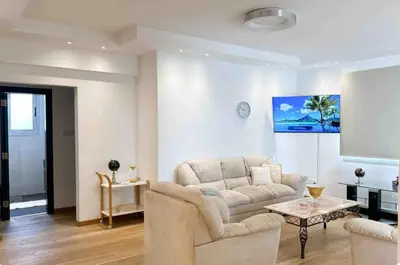 a living room with a couch and a table at Neptune Apartment in Larnaka