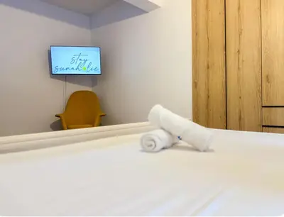 a room with a bed with a towel on it at Neptune Apartment in Larnaka