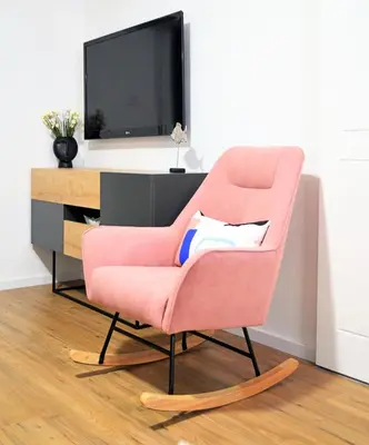 a pink chair sitting in front of a tv at Modern apartment near McKenzie beach in Larnaka
