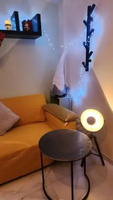 a living room with a couch and a stool at Safari House with fireplace in Agros